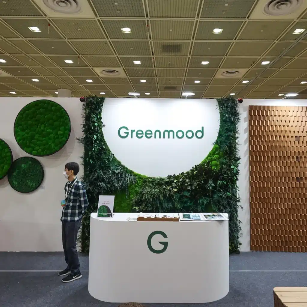 Greenmood exhibition booth with greenery and decor.