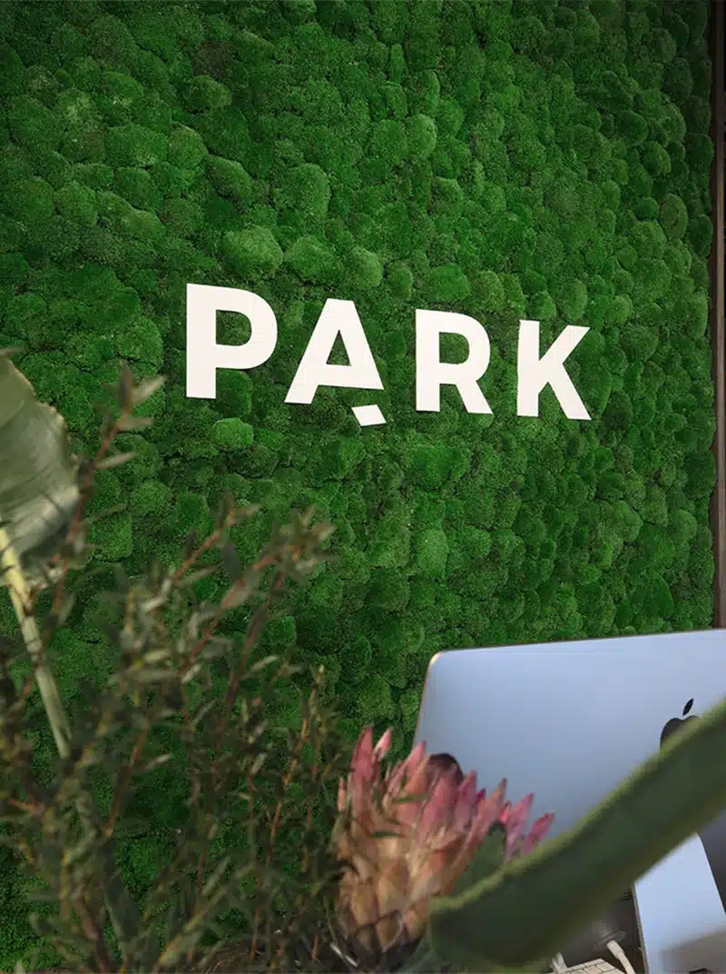 Green moss wall with 'PARK' sign